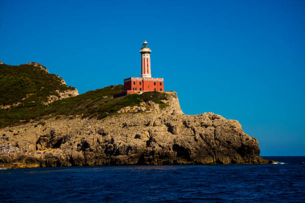 Capri Island - Punta Carena on which stands a lighthouse immersed in the Mediterranean scrub with this mantle of pines shaped by the wind that recalls the Norwegian fjords when the sea is stormy.