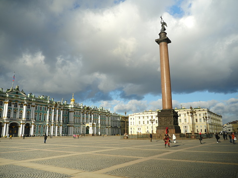 St. Petersburg, Russia, January 29, 2020. low heavy clouds over the Palace Square, the Winter Palace and the Alexander Column, tourists walk see the sights