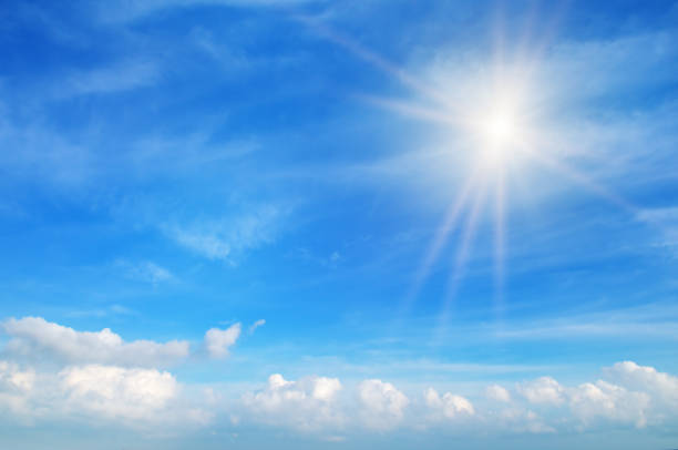 istock Beautiful, blue summer sky with fluffy clouds and bright sun as a background 1307791023