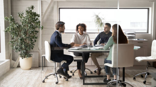 istock Diverse colleagues brainstorm at office team meeting 1307791585