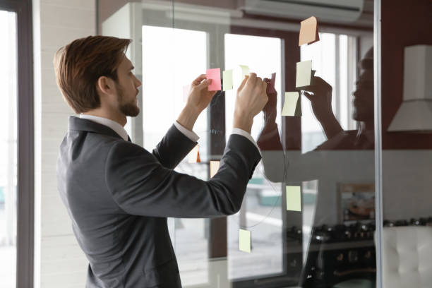 istock Young Caucasian male employee engaged in creative thinking 1307791686