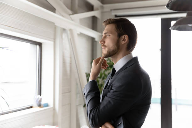 istock Pensive businessman look in distance thinking planning 1307791699