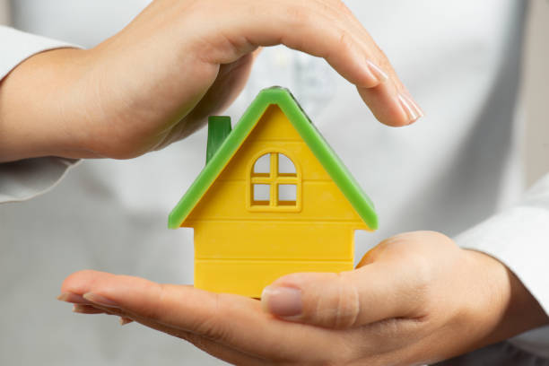 istock Woman Holding Toy House 1307792577