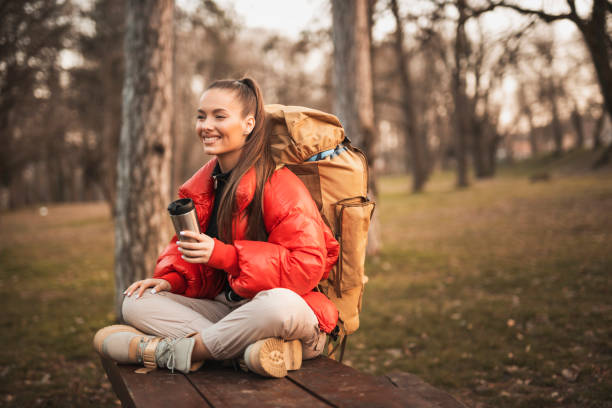 istock Beautiful young woman drinking coffee and taking a break while hiking in the mountains 1307793077