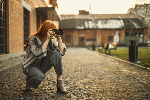 Fashion blogger with photo camera at the street