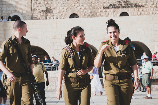 Three Israeli soldiers walk at the Western Wall Plaza in Jerusalem on October 20, 2010.