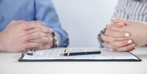 istock Couple with divorce contract and ring. Divorce 1307796940