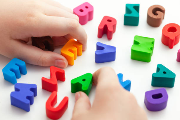istock A child trying to spell a word with letters 1307798776