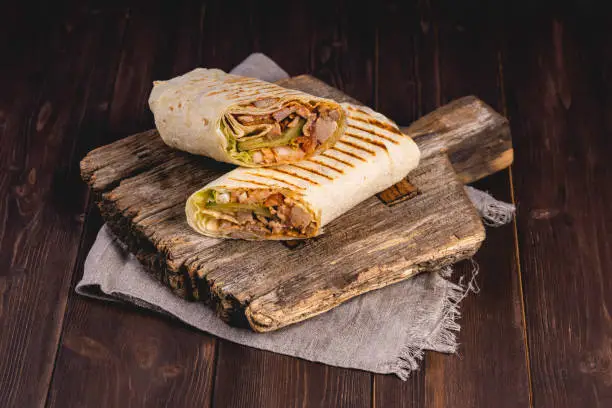 A cut kebab, shawarma, with grilled meat and vegetables. Delicious shawarma sandwich.