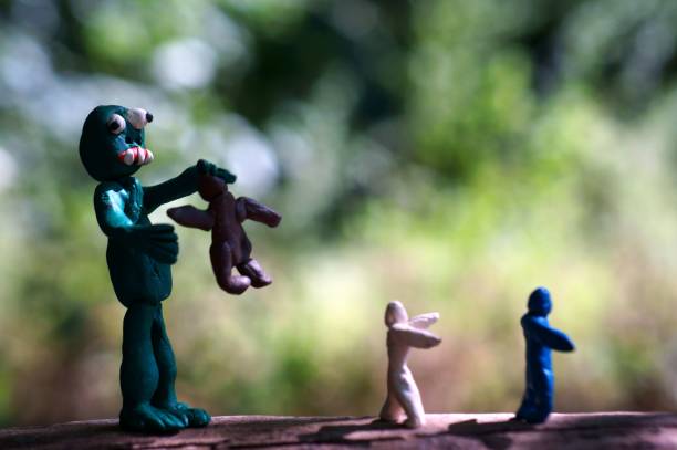 istock A zombie figurine made of plasticine and small men. 1307799774