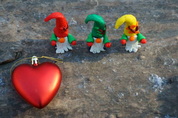 istock Figures of three dwarfs in a snowy forest. 1307800029