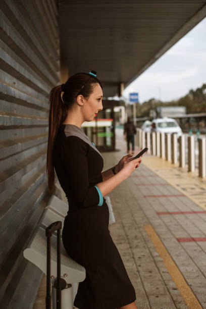 istock Young air stewardess using her smart phone 1307800108