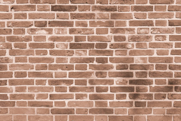 istock A wall of old, cracked bricks, with a weathered and faded surface. 1307802008