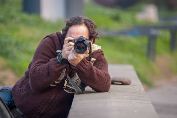 istock Man with camera taking picture in the street 1307802994