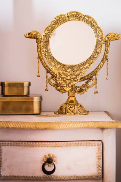 istock a beautifully decorated golden mirror standing on a stylish bedside table. Feminine elegance, warm colors 1307804699