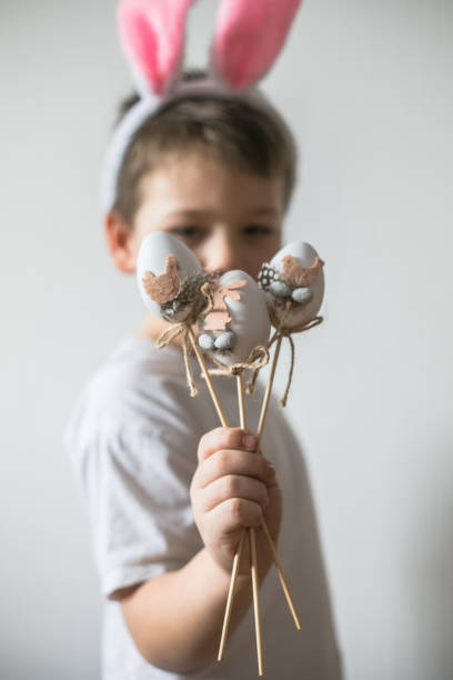 istock Little cute boy  wearing Easter bunny ears, smile with easter eggs 1307807049