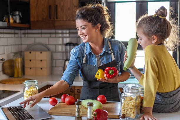 istock Mother and daughter having fun in the kitchen 1307807765