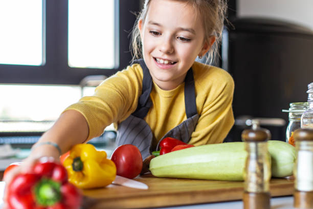 istock Young girl having fun in the kitchen and cooking 1307807833
