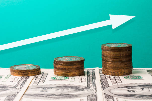 istock Coins, dollars and arrow pointing up, growth concept 1307807931