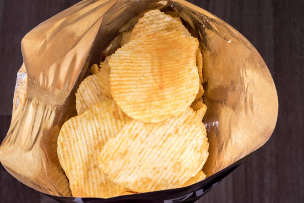 istock potato chips in the pack, unhealthy food concept 1307808003
