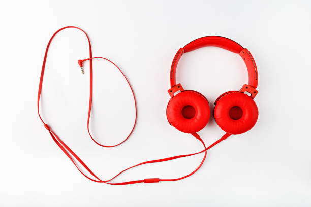 istock Red round headphones with a cord forming a frame flat lay on a white background with a copy space 1307808694
