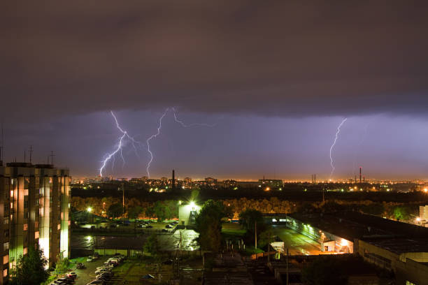 istock Powerful lightning strike hits the city at night. A strong lightning strike over a dark gray sky hits the ground, illuminating the town 1307808868