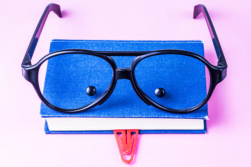 Book, glasses, paperclip and buttons look like face