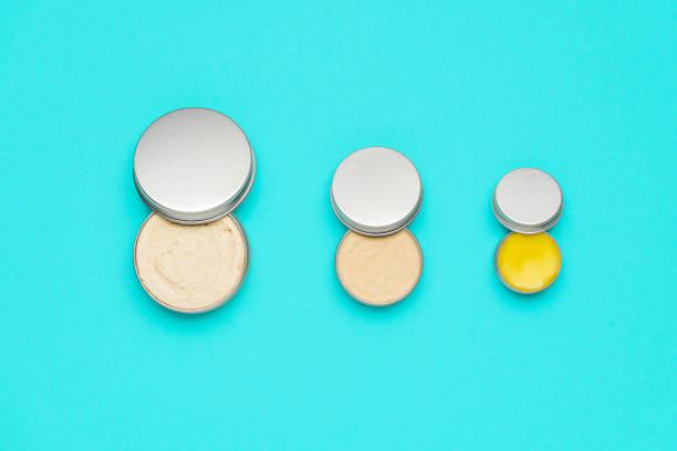 Natural cosmetics in metal cans, isolated on a blue background.