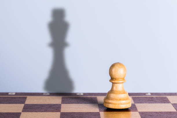 istock White chess pawn with king shadow. Hidden opportunities concept 1307809194