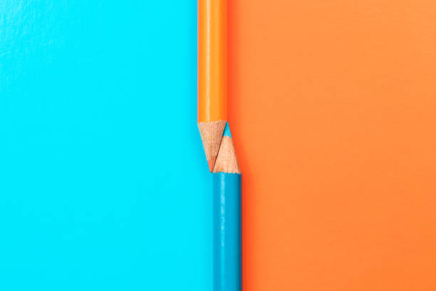 istock Two colored pencils on the border of different colors. 1307809468