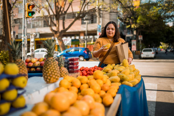 istock Woman putting fruit at paper bag 1307810285