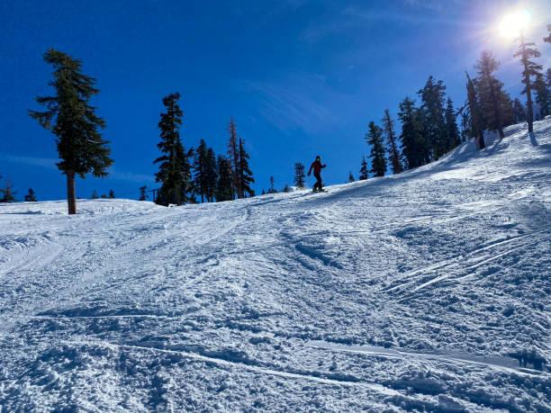 snowboardzista w truckee w kalifornii schodzi ze stoku i w piękny słoneczny dzień - skiing snow snowboarding winter sport zdjęcia i obrazy z banku zdjęć