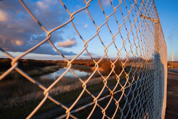 istock Lake area surrounded by fence 1307812125