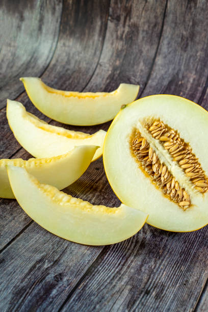 istock Yellow honeydew with dark wooden background 1307812513