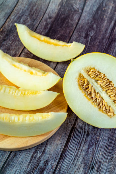 istock Yellow honeydew with dark wooden background 1307812648