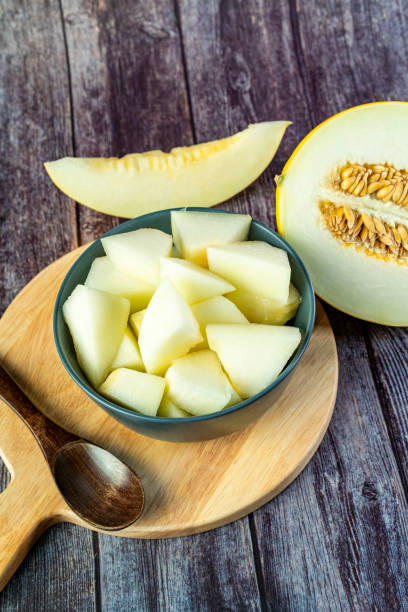 istock Yellow honeydew with dark wooden background 1307812655