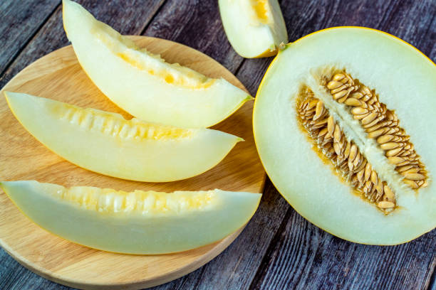 istock Yellow honeydew with dark wooden background 1307813192