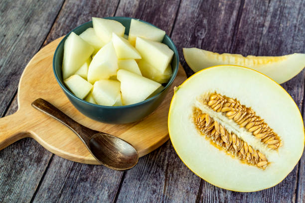 istock Yellow honeydew with dark wooden background 1307813194