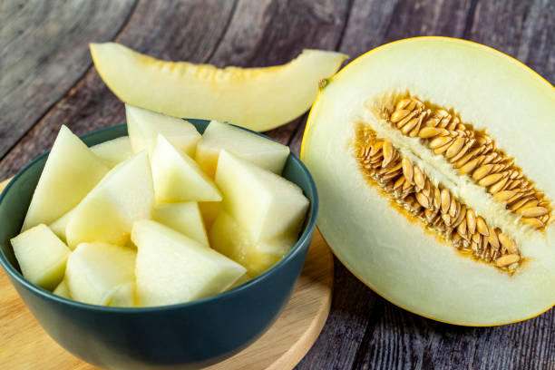 istock Yellow honeydew with dark wooden background 1307813287