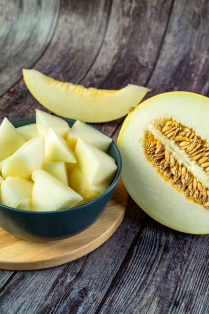 istock Yellow honeydew with dark wooden background 1307813410