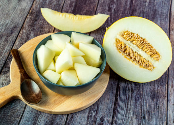 Yellow honeydew with dark wooden background