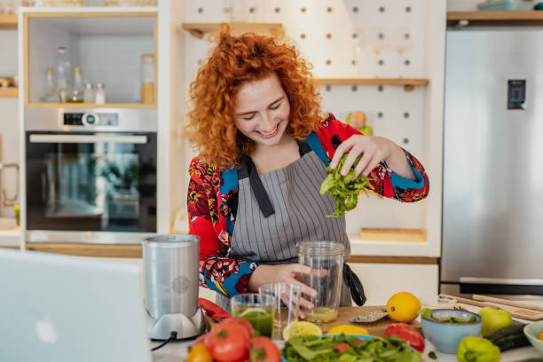 istock Young woman prepares a healthy drink 1307813496