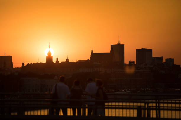 istock People looking at the sunset over the city 1307813519
