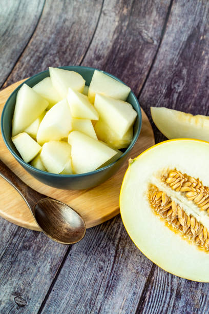 istock Yellow honeydew with dark wooden background 1307813615