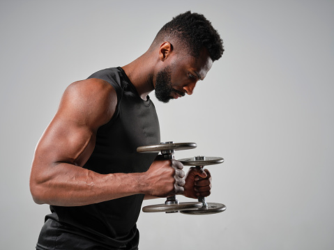 A physically fit man in a studio.