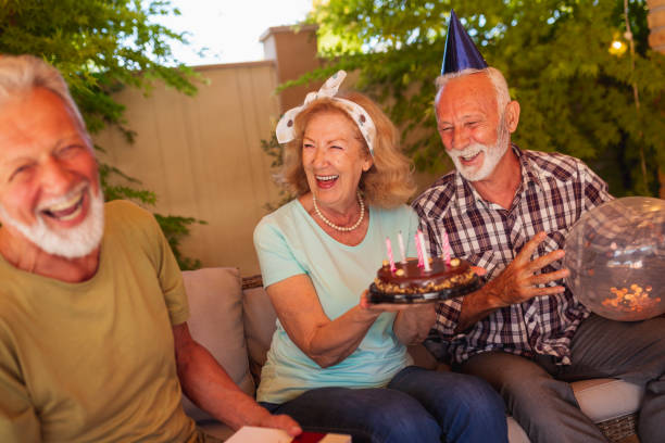 istock Senior friends having a birthday party 1307814775