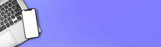 istock Business banner with smartphone mockup screen, blank white screen, office table and desk with blue background, copy space 1307816961