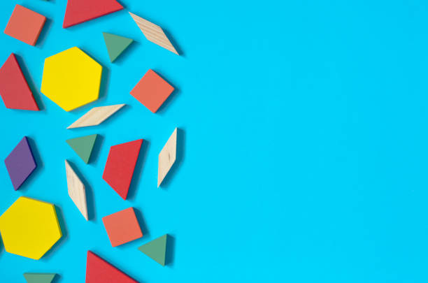 istock Wooden multicolored geometric shapes. Elements of children's multicolored constructor on a blue background with a place for text 1307817352