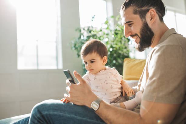 istock Father showing little daughter something on phone 1307819665