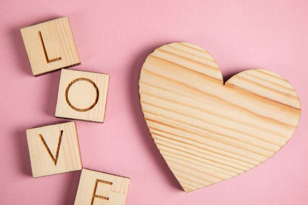 istock wooden heart and love text 1307822906